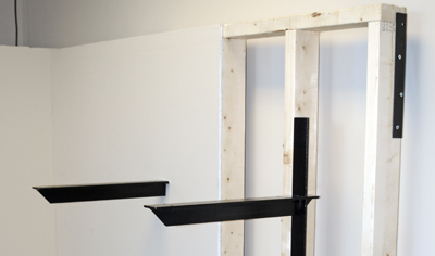 two extended concealed brackets, one behind drywall and one in an open wall
