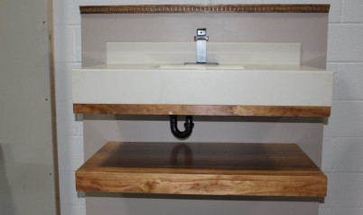 A wide shot of a sink and table held up using the floating vanity bracket showing that the bracket and even the inlaid sink are hidden